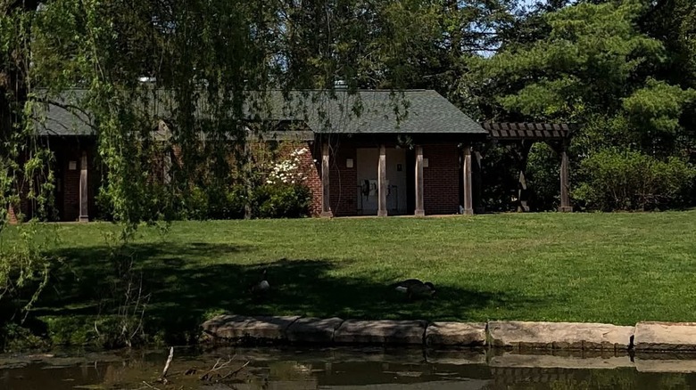 Pond-side pavillion in Succop Nature Park surrounded by green grass and trees
