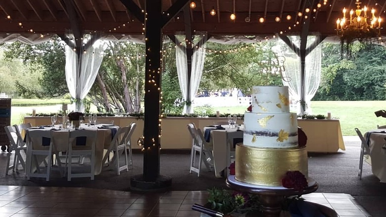 Pavillion at Succop Nature Park set for a wedding reception, with a cake in the foreground