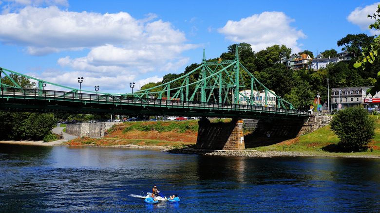 A view of the bridge and river with a kayaker on the water in Easton, Pennsylvania