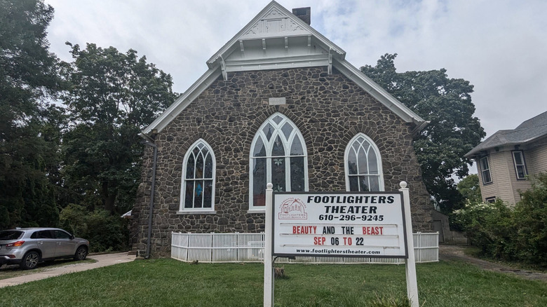 The exterior or the Footlighters Theater, advertising a showing of "Beauty and the Beast"