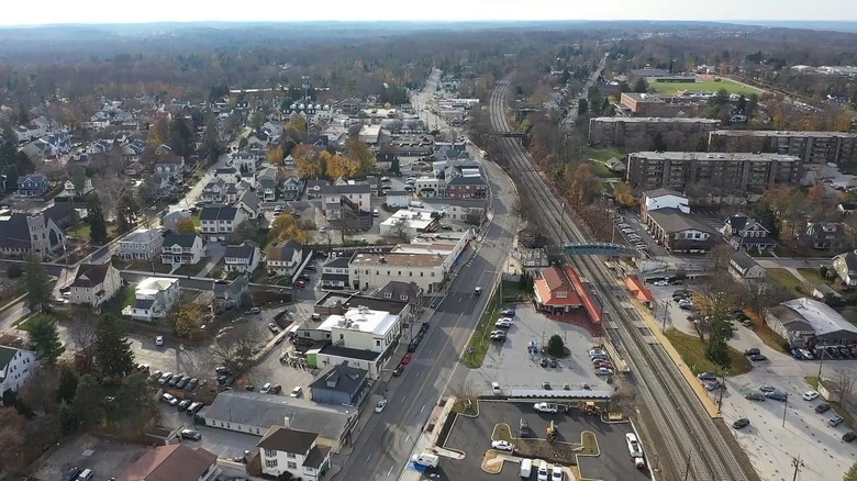 An aerial view of Berwyn showing railroad tracks, cars on streets, and low buildings