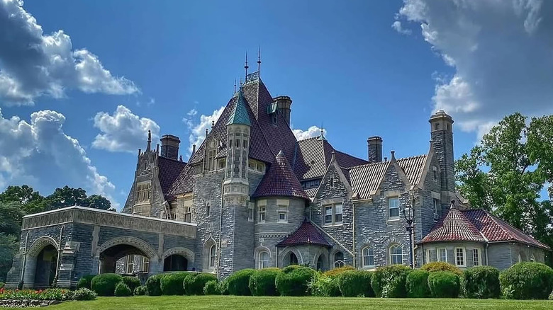Stone mansion in Gladwyne, Pennsylvania, surrounded by trees under a blue sky