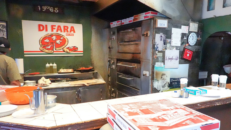 Di fara oven with sign and pizza boxes