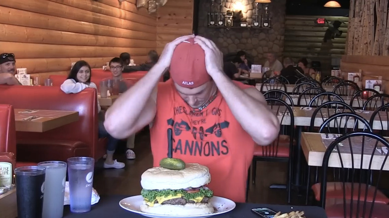 Randy Santel preparing to eat the Kookamonga Burger