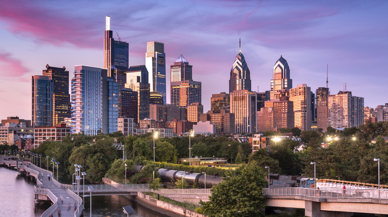 Skyline of Philadelphia, with trees and the Schuylkill Riverwalk in the foreground
