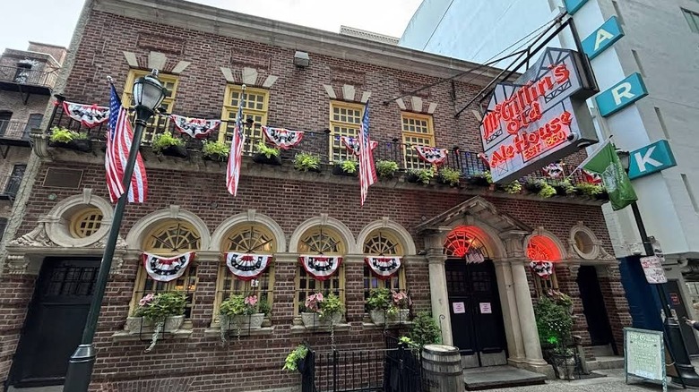 A shot of the neon sign hanging on the historic brick facace of McGillin's Olde Ale House in Philadelphia, Pennsylvania
