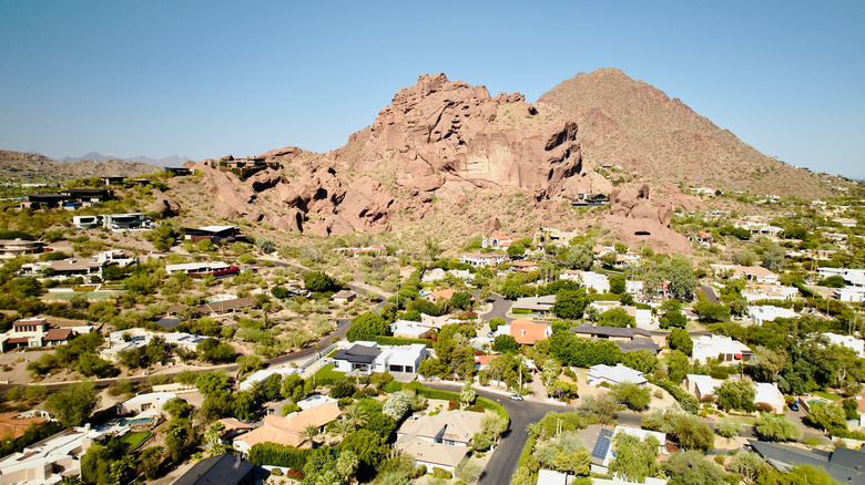 An aerial view of Arcadia houses and lawns with Camelback Mountain in the background.