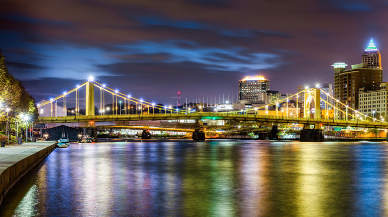A view of the Roberto Clemente Bridge over the Allegheny River at night