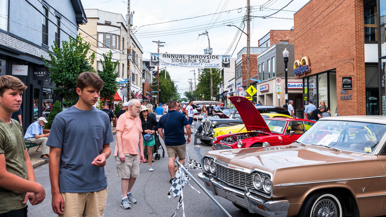 Crowds of people gaze on cars at a vintage car display in Shadyside, Pittsburgh