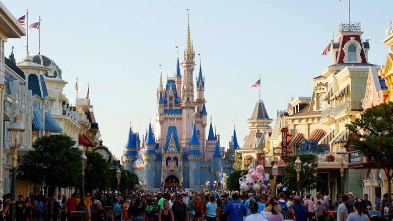 People walking along Main Street USA towards Cinderella's Castle at Walt Disney World in Orlando, Florida