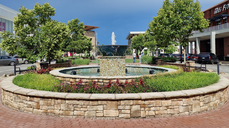 A fountain with green landscaping at The Shops at Perry Crossing in Plainfield Indiana