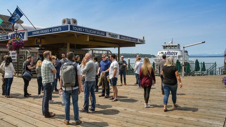 A crowd of people wait to board the Argosy cruise boat in Seattle.
