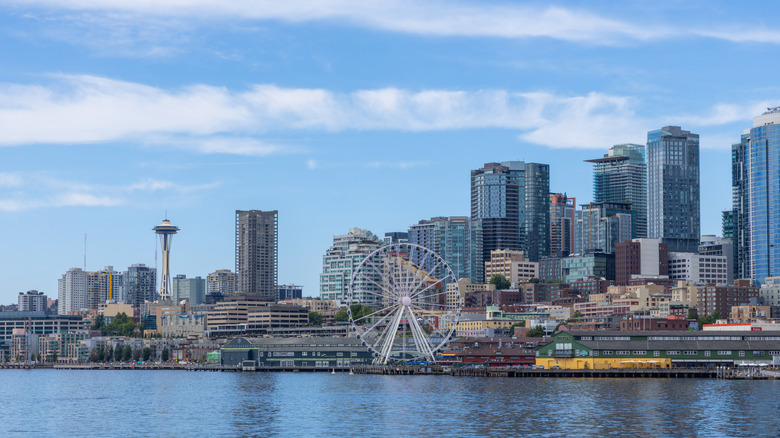 view of Seattle city waterfront from Puget sound; the Great Wheel, the Space Needle, Pike Place Market, and the piers are all visible
