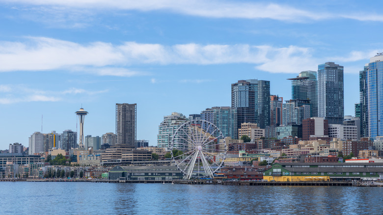 view of Seattle city waterfront from Puget sound; the Great Wheel, the Space Needle, Pike Place Market, and the piers are all visible