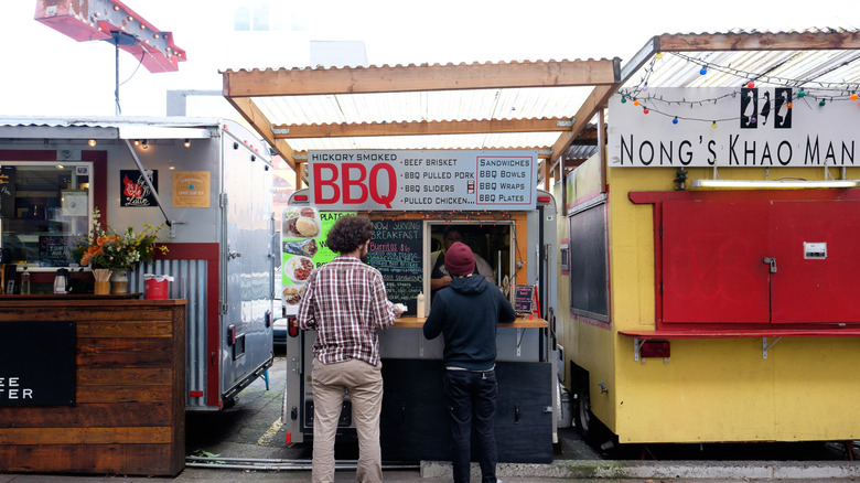 People ordering barbecue from a Portland food stall.