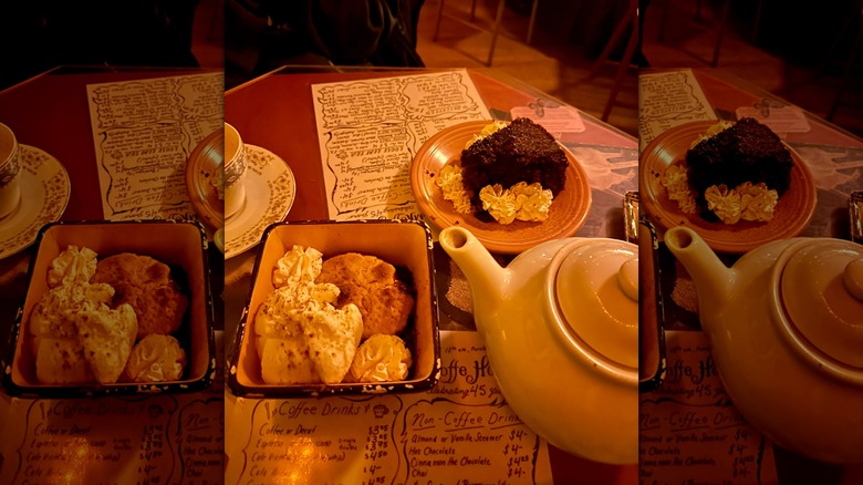Desserts with a pot of tea on a table