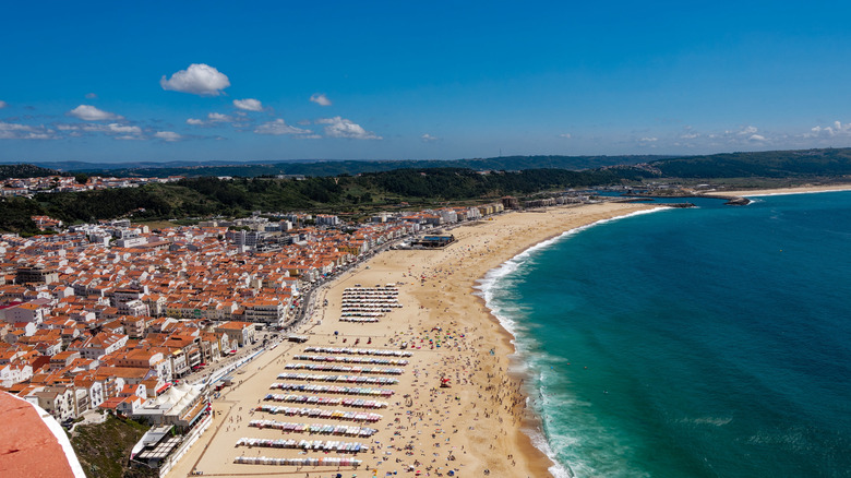 Aerial view of a seaside village with red-roofed buildings, Nazaré