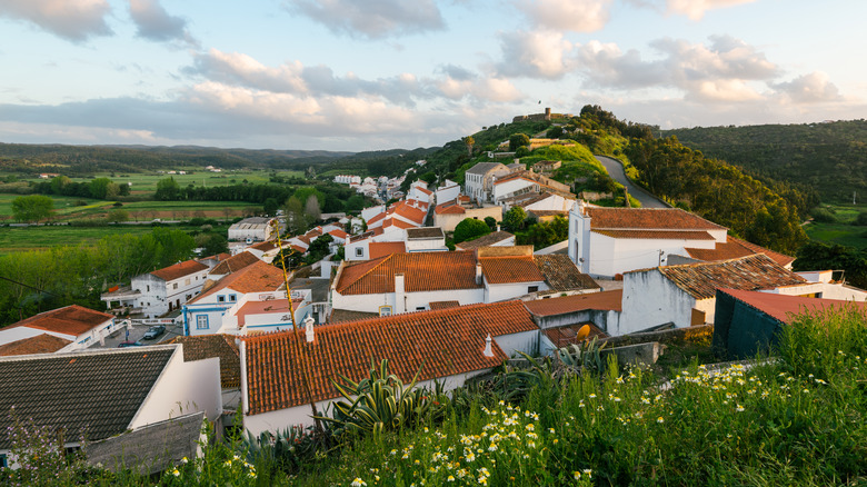 The red-tiled roofs of Aljezur's old town on a hill