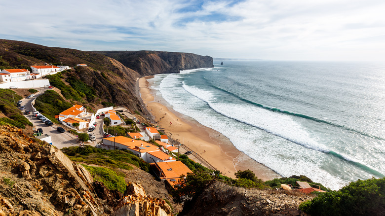 Cliffs and rock stacks rise above Arrifana Beach, Portugal