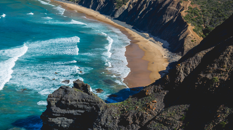Waves crashing into the beachfront of Arrifana Beach