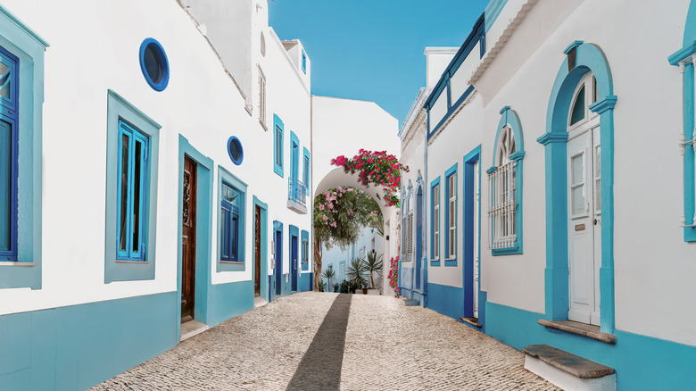White and blue buildings lined up together in Olhão, Portugal