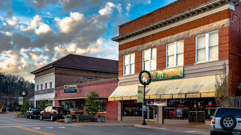 Shops and restaurants in historic brick buildings against cloudy sky Prattville Alabama