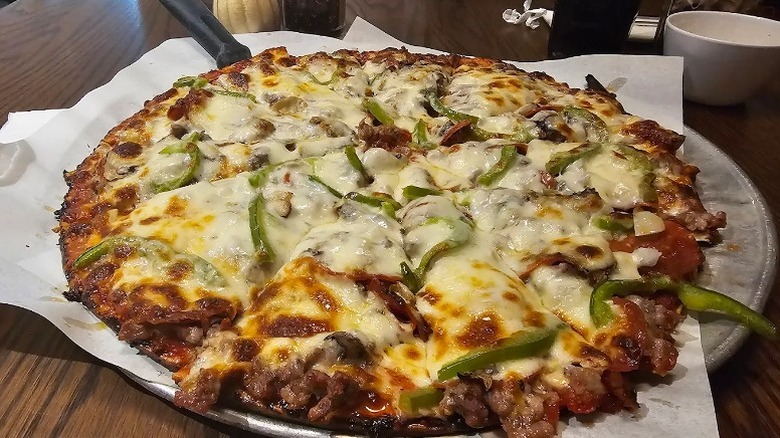 A thin-crust, cheese-topped pizza served on a tray at Pagliai's Pizza