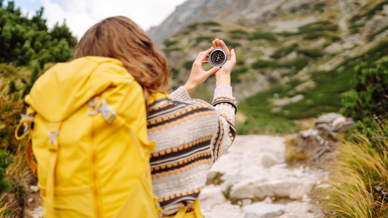 A hiker looking at her compass
