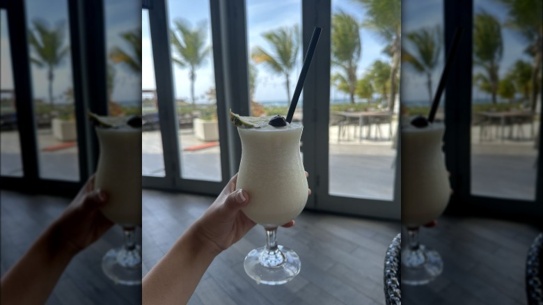 Person holding Pina Colada at Caribar