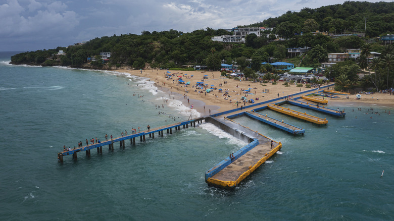 Beachgoers on pier at Crash Boat Beach