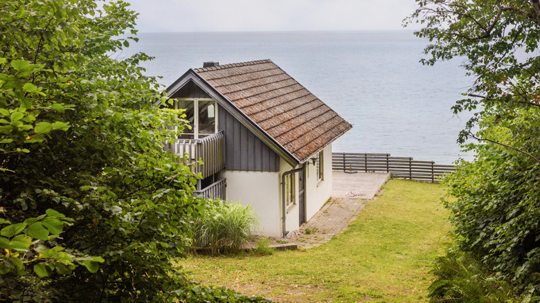 A close-up of a cabin on a shore during a beautiful summer day in rural Sweden