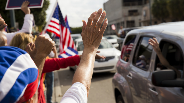 drivers passing by a political gathering show their support