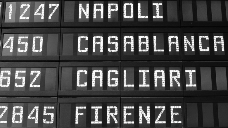 Departure schedule at an airport in Italy. Flights to Naples, Casablanca, Cagliari and Florence.