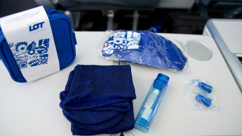 Premium economy amenity kit contents displayed on tray table