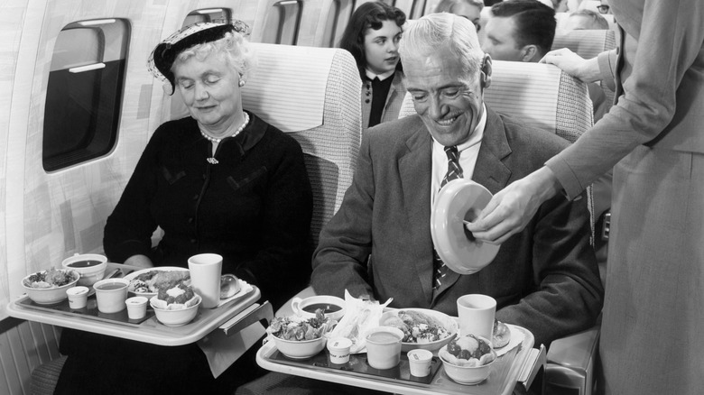 Passengers enjoy a meal inside a mock-up of the Boeing 707 Stratoliner.