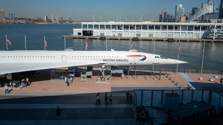 British Airways Concorde displayed at the Intrepid Sea, Air & Space Museum with waterfront and city skyline in the background,