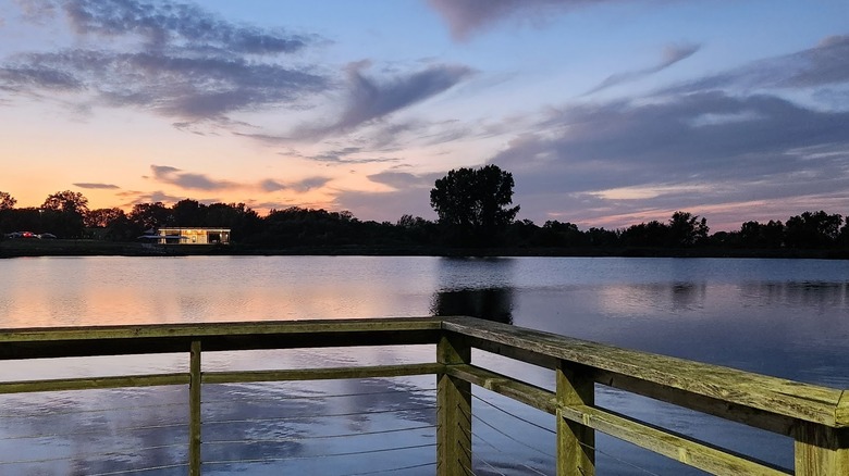 Johnston Lake with calm waters at Hawk Ridge Park during sunset in Raymore, Missouri