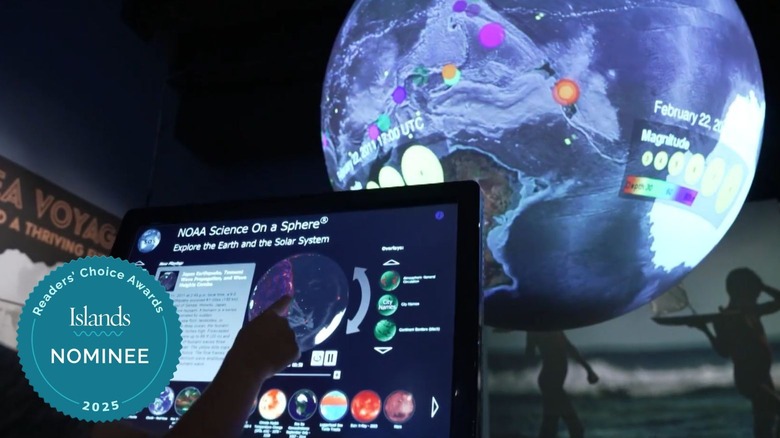 Kid playing with planet toy at ʻImiloa Astronomy Center, Big Island