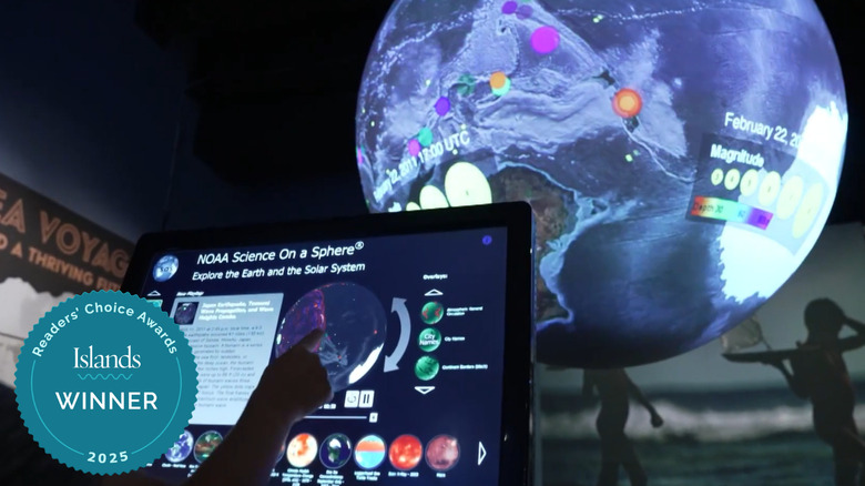 Kid playing with planet toy at ʻImiloa Astronomy Center, Big Island