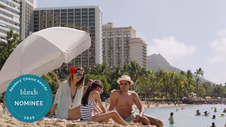 A family lounging on the beach at Aston Waikīkī Beach Tower