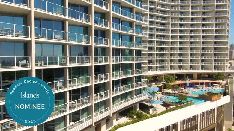 Rows of balcony rooms and the swimming pool at The Ritz-Carlton Residences, Waikīkī Beach