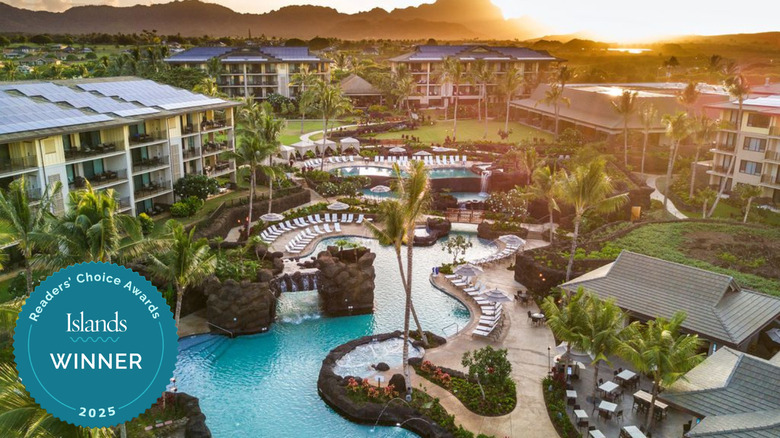 Kōloa Landing's main pool with view of the mountains at sunset