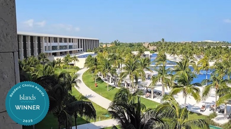 Pool area surrounded by trees at Barceló Maya Riviera - Adults Only