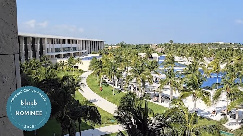 Pool area surrounded by trees at Barceló Maya Riviera - Adults Only