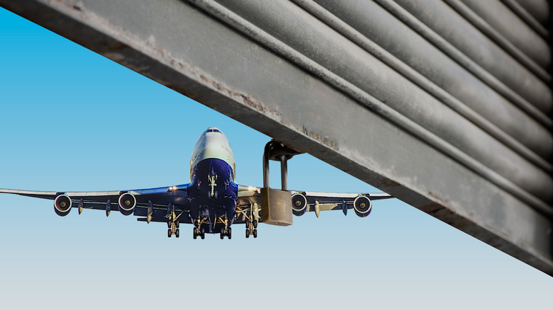 An airplane flies near hangar