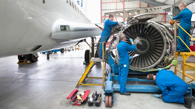 Engineers working on an engine