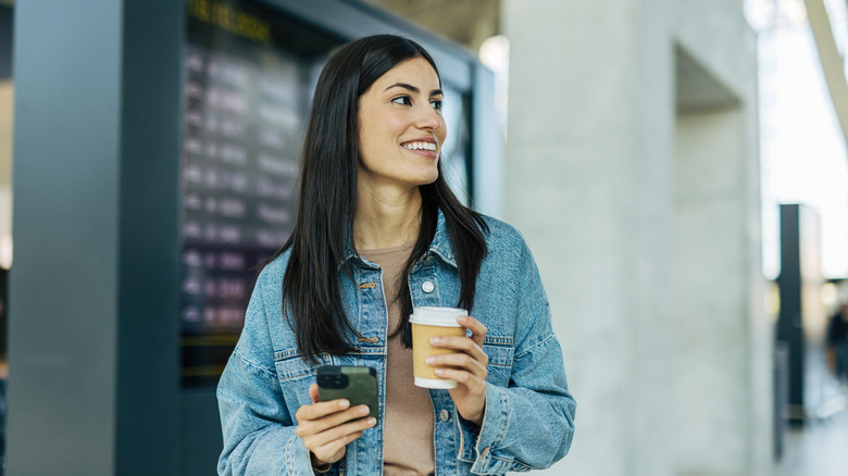 Woman at airport without luggage