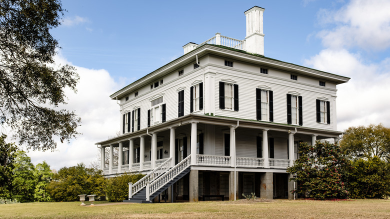 white, square three-story plantation home