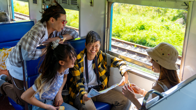 A group of four friends enjoying a train ride