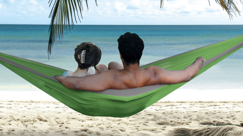 Man and woman resting in a Costco Cascade Oasis hammock